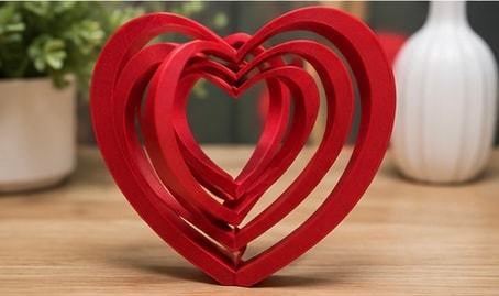 Red nested hearts on wooden table
